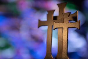 Several gold-colored cross table decors in selective focus photography