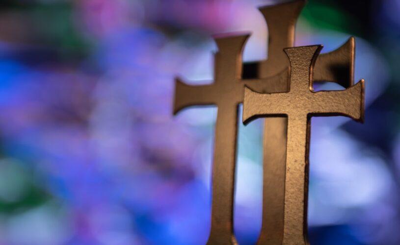 Several gold-colored cross table decors in selective focus photography